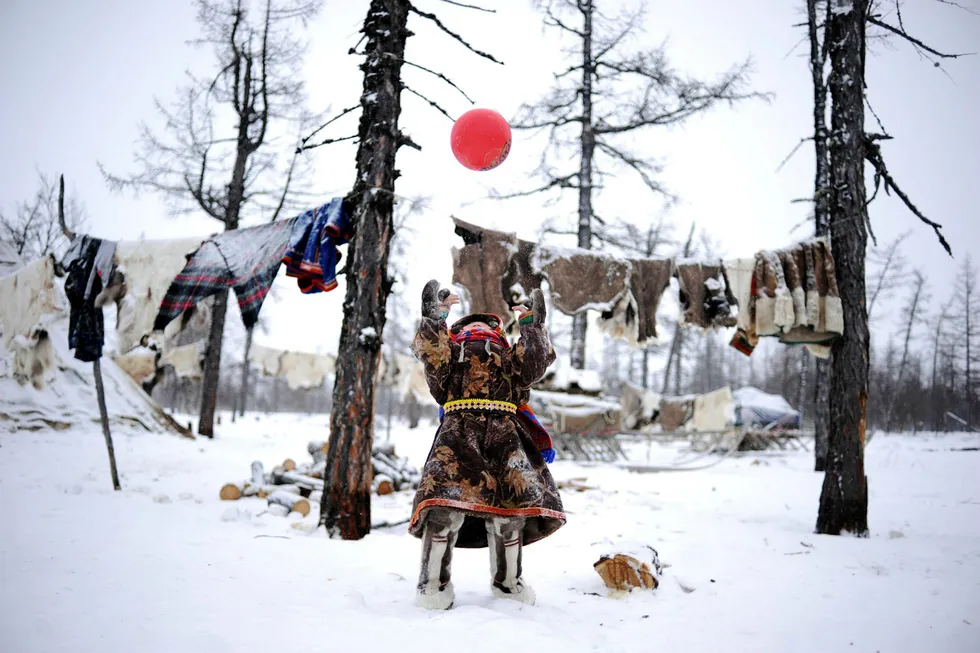Rising hopes: children of reindeer herders play with a ball in remote Yamal-Nenets region in Russia