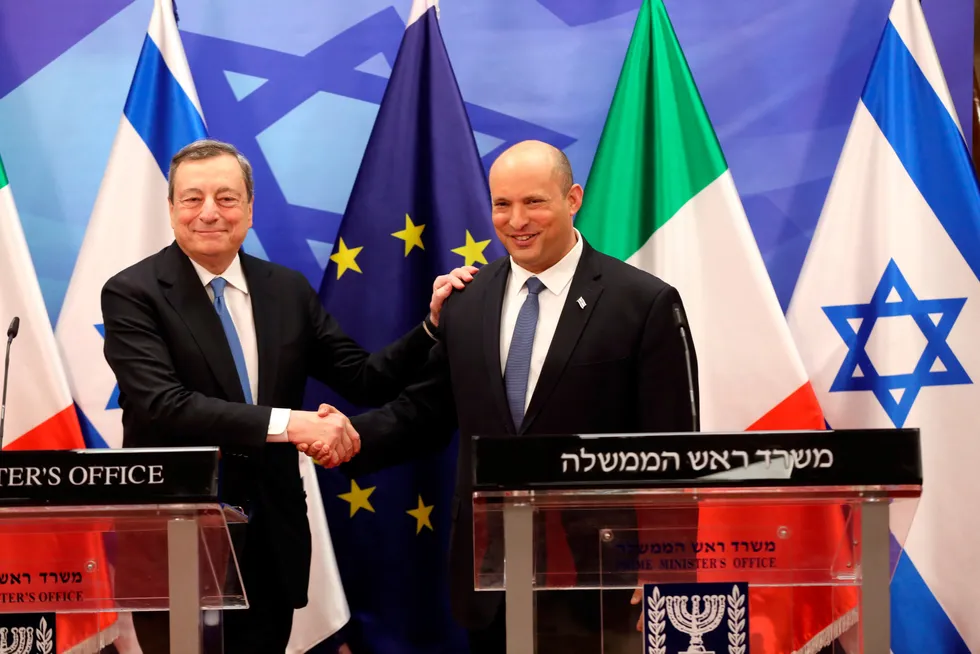 All smiles: Italian Prime Minister Mario Draghi, left, shakes hands with Israeli Prime Minister Naftali Bennett during a press conference in Jerusalem on 14 June 2022