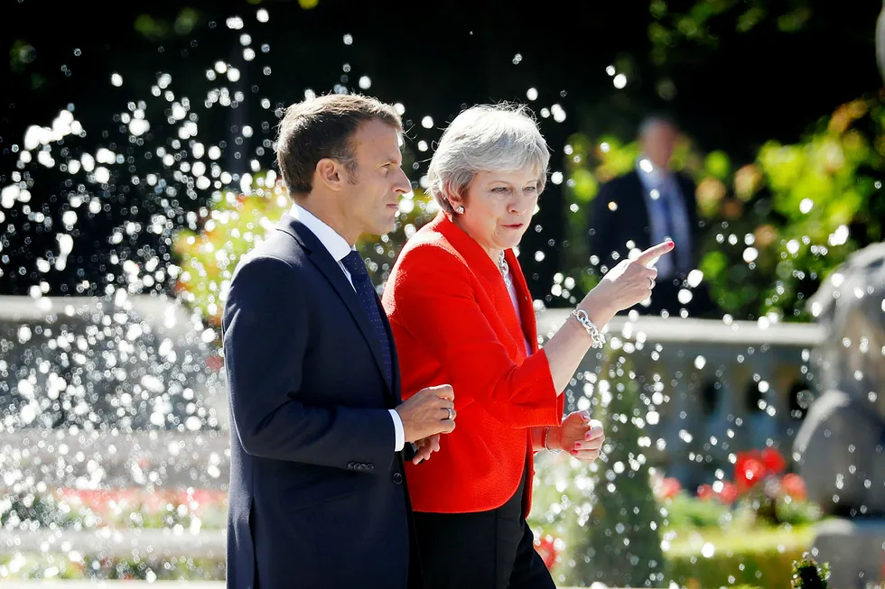 Britain's Prime Minister Theresa May and French President Emmanuel Macron arrive for a family photo during the European Union leaders informal summit in Salzburg, Austria, September 20, 2018. REUTERS/Leonhard Foeger ---