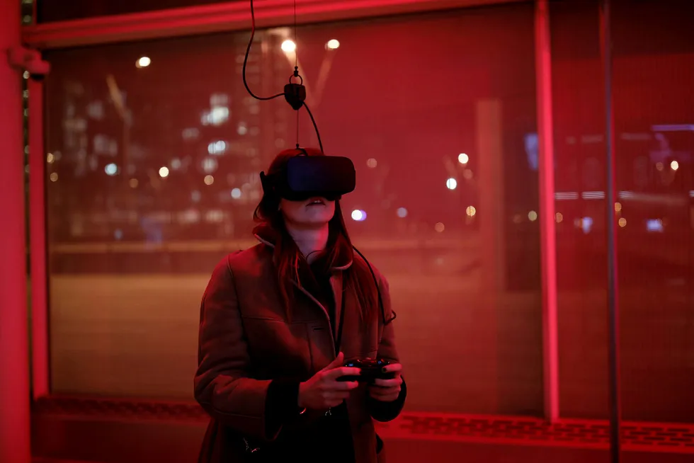 Oculus er dømt til å betale erstatning for å ha benyttet stjålet datateknologi. På bildet spiller en kvinne videospill med Oculus Rift VR-briller. Foto: Benoit Tessier/Reuters/NTB scanpix