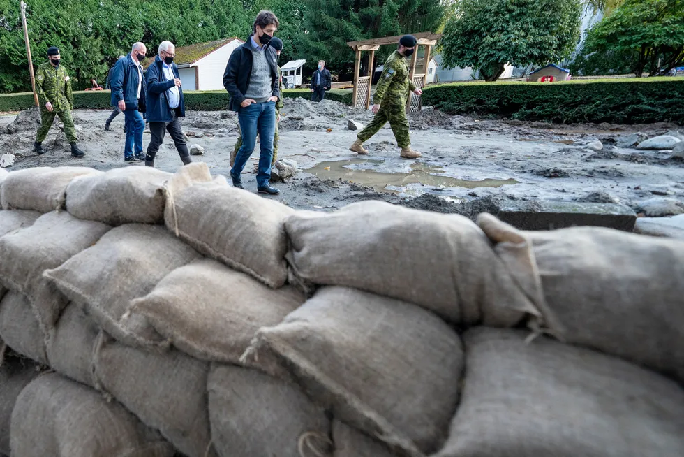 Aftermath: Canadian Prime Minister Justin Trudeau surveys the damage after heavy rains caused flooding and landslides near Vancouver in November