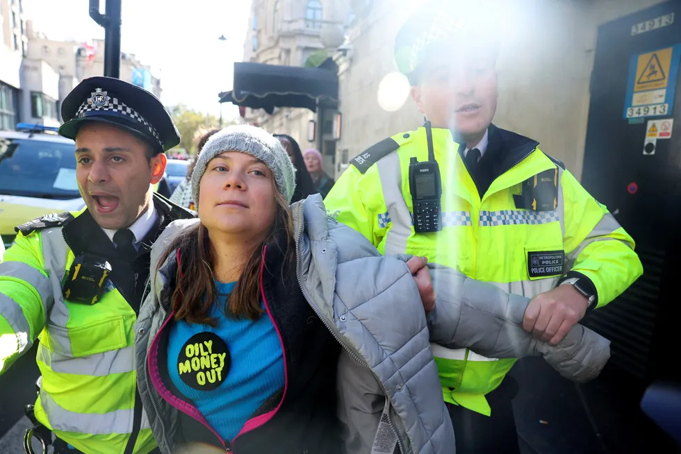 Police officers detain Swedish climate campaigner Greta Thunberg, during an Oily Money Out and Fossil Free London protest in London