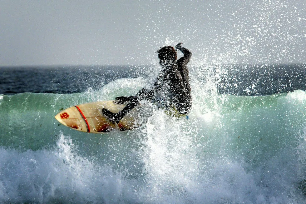 Pressing on: a surfer catches a wave off the Cap Vert peninsula in Senegal's capital Dakar