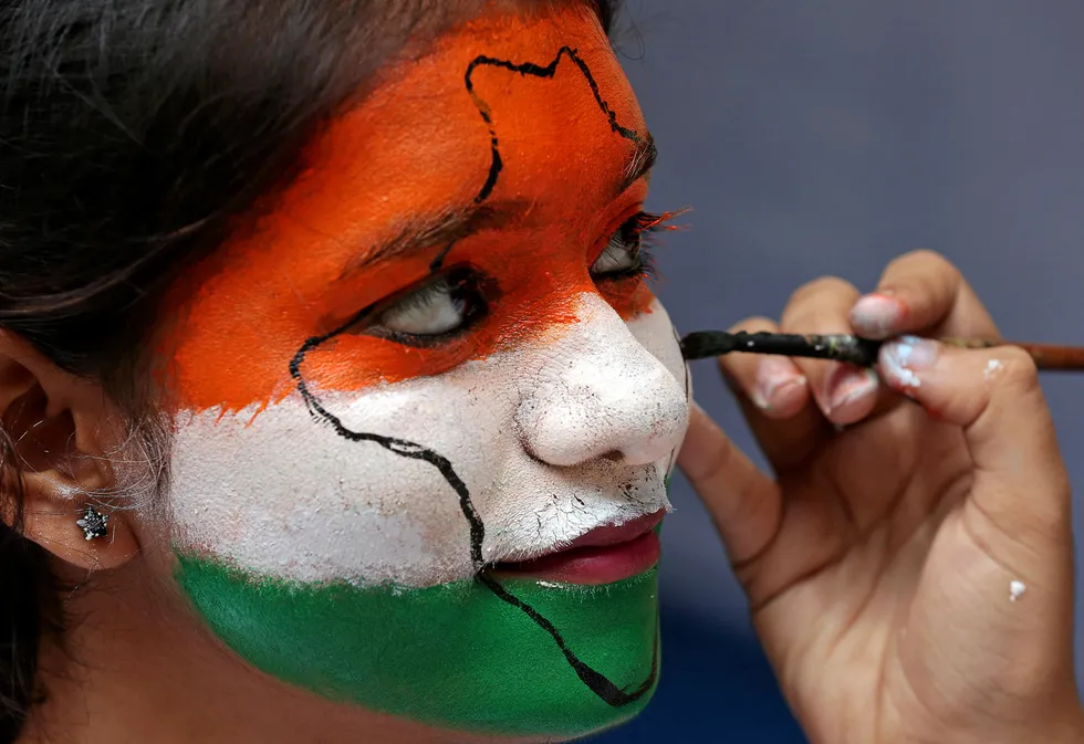 Bid round: a girl gets her face painted in the colours of India's national flag