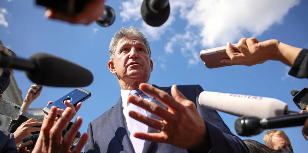 Senator Joe Manchin, who has held up the bill containing the PTC, surrounded by reporters on Capitol Hill.