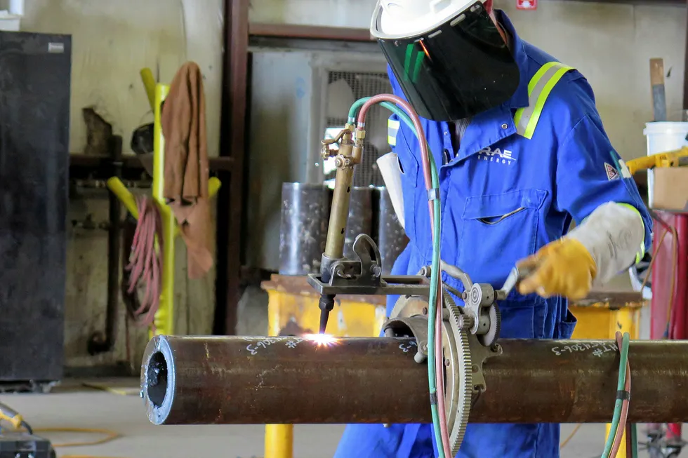 Process: a worker during welding and testing at Emas Chiyoda Subsea's spoolbase in Ingleside, Texas