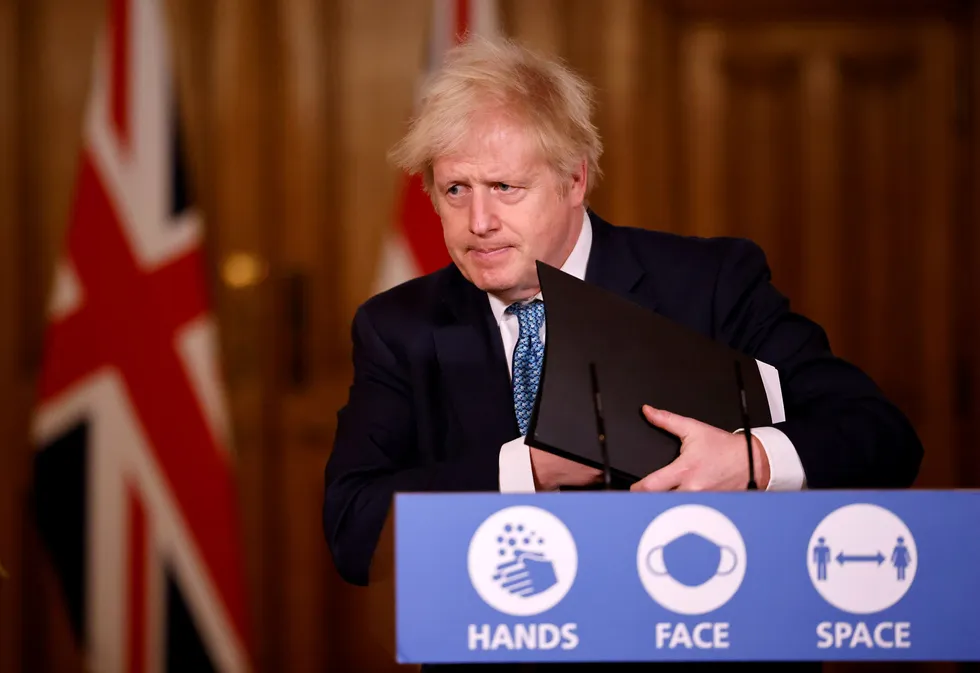 Britain's Prime Minister Boris Johnson leaves after attending a virtual press conference after a string of countries banned travellers and all but unaccompanied freight arriving from the U