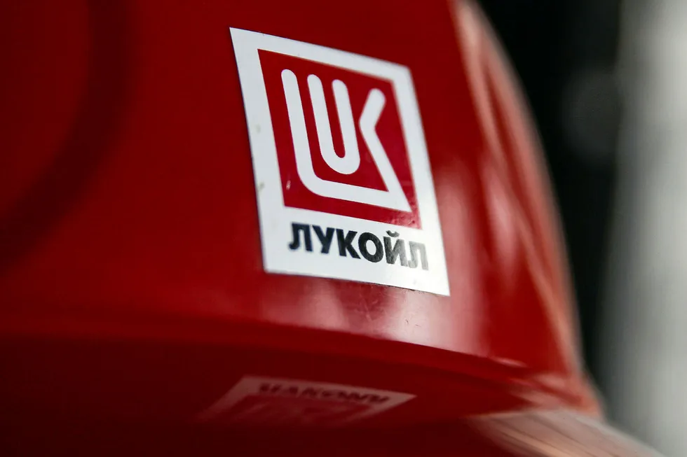 Red zone: Lukoil company logo is pictured on a worker's helmet at the Filanovskogo oil production platform in the Caspian Sea in Russia