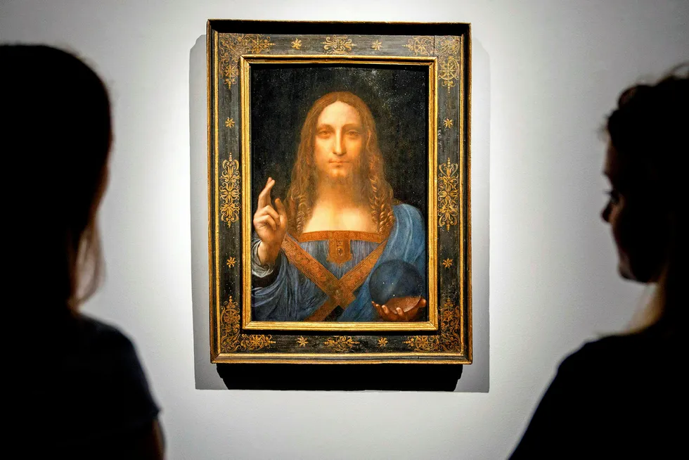 Masterwork: staff at at Christie's auction house in central London admire Leonardo da Vinci's Salvator Mundi, which The Louvre Abu Dhabi plans to unveil soon