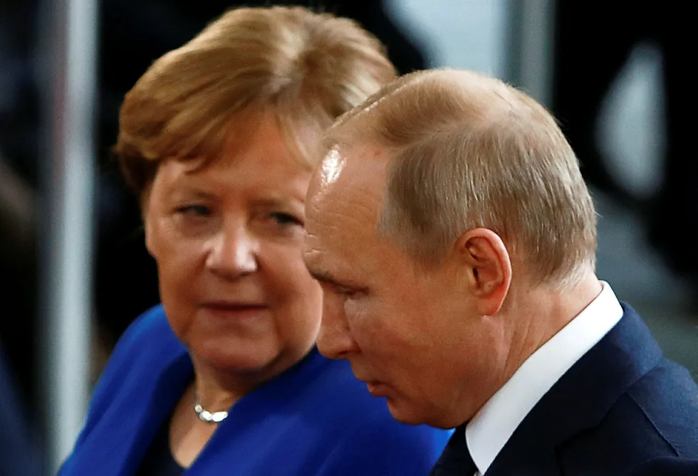 Different times: German Chancellor Angela Merkel (left) talks with Russian President Vladimir Putin on 19 January, 2020