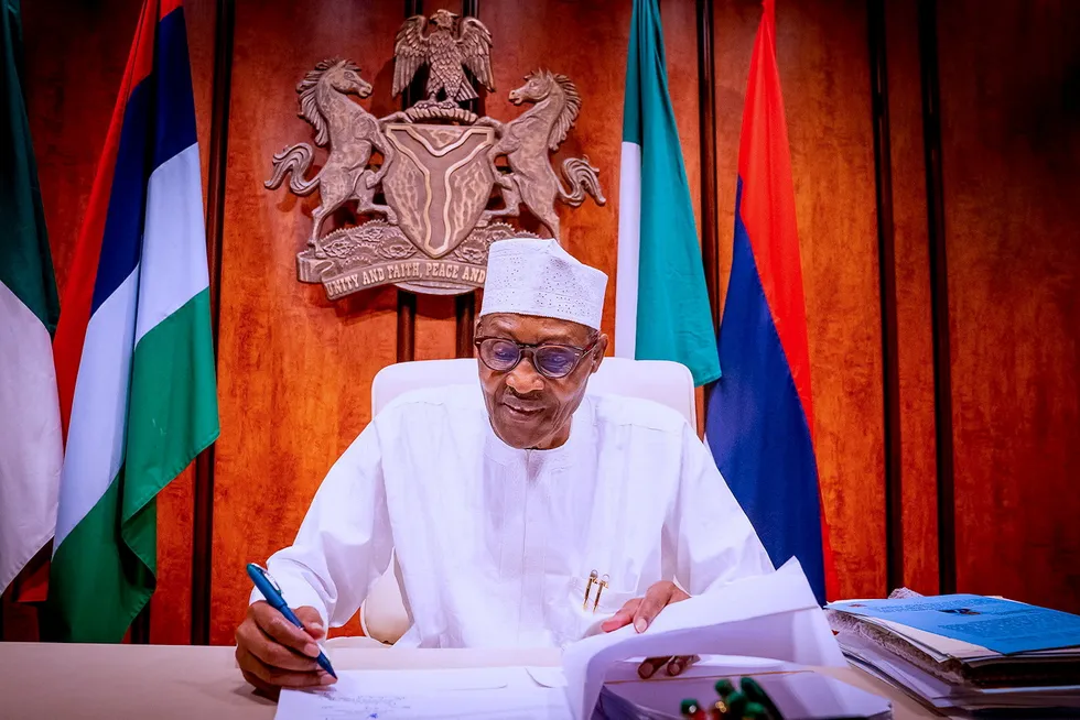 New law finalised: Nigeria's President Muhammadu Buhari signs the Petroleum Industry Bill (PIB) into law at the state house in Abuja, Nigeria on 16 August 2021