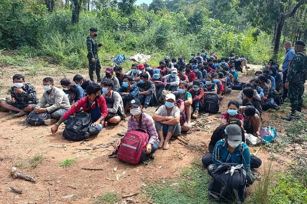 Apprehended: Myanmar migrants who had fled across the land border to Thailand