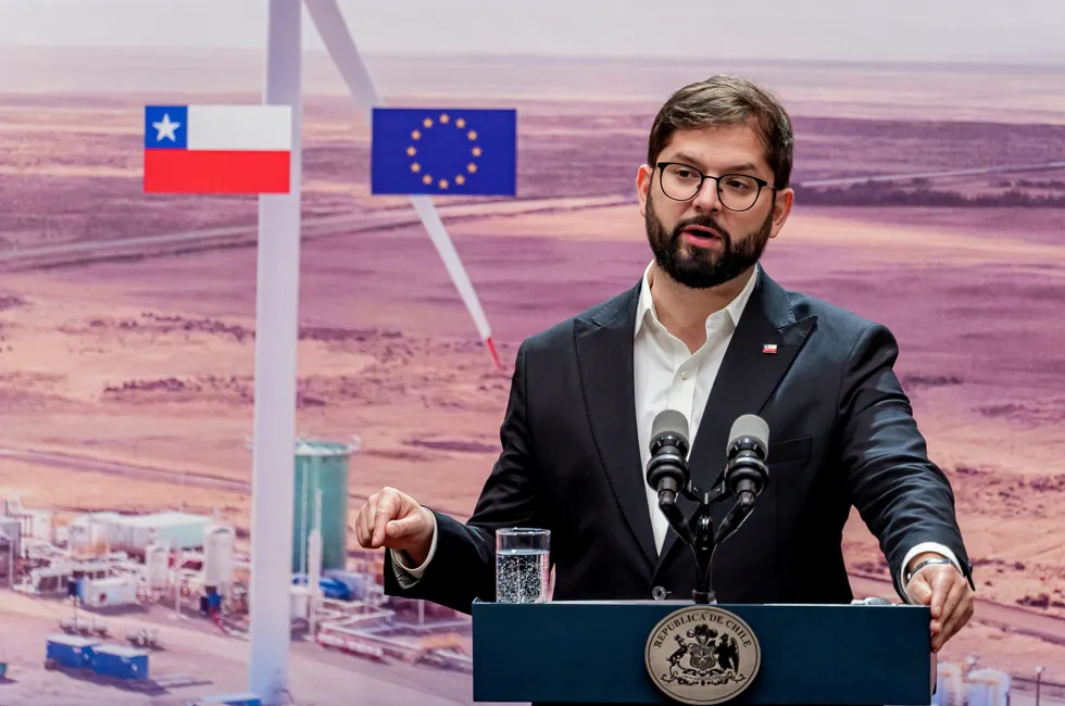 President of Chile Gabriel Boric speaking in front of a photo of HIF Global's Haru Oni green hydrogen/e-fuels project in the Magallanes region during a visit by European Commission President Ursula von der Leyen to Santiago last June.