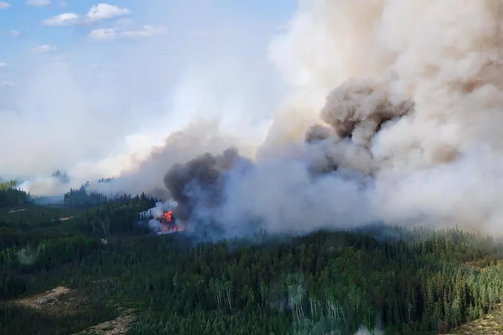 Slashed production: wildfires in Alberta, Canada, kept output levels down and threatened oil sands operations.