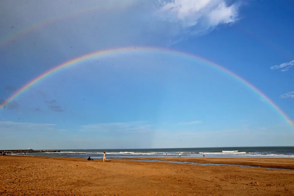 Testing the waters: a rainbow seen from the beach in Mar de Plata, Argentina
