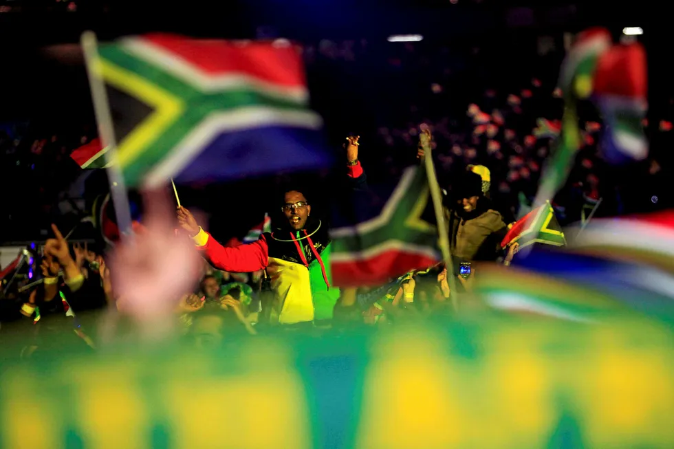 Celebrations: a man waves a South African flag