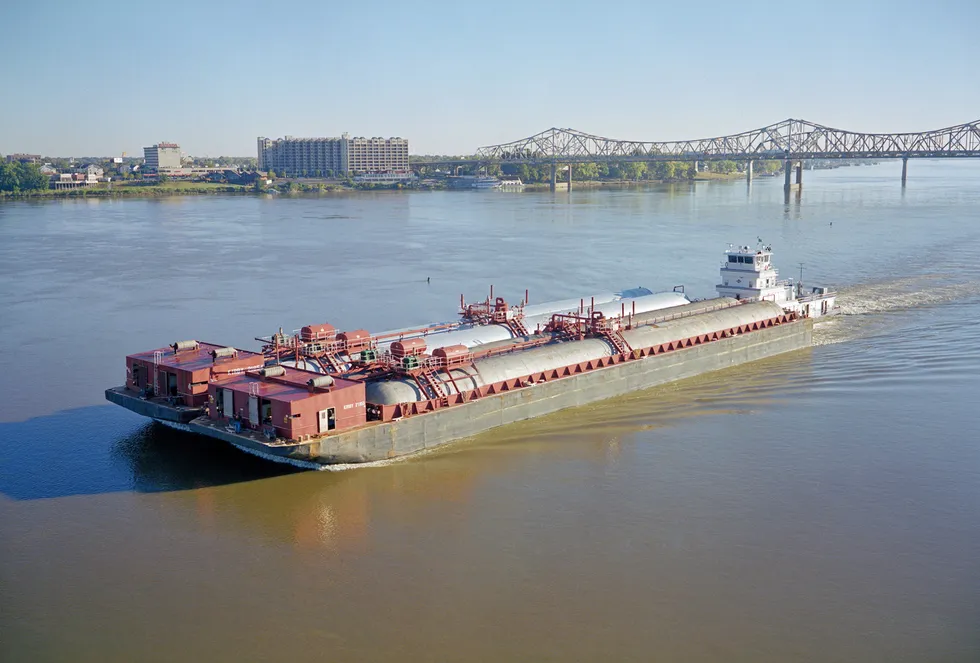 A towboat pushes two ammonia tanker barges along the Ohio River on the border between the US states of Kentucky and Indiana.