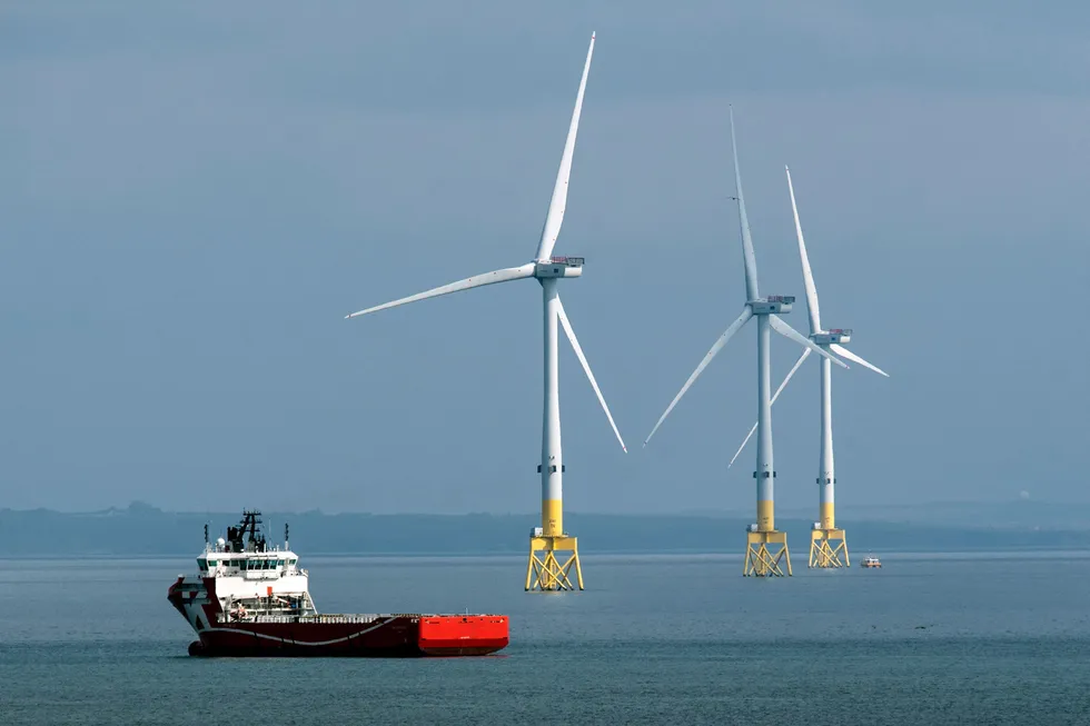 Building capability: an offshore vessel navigates past wind turbines off the coast of Aberdeen