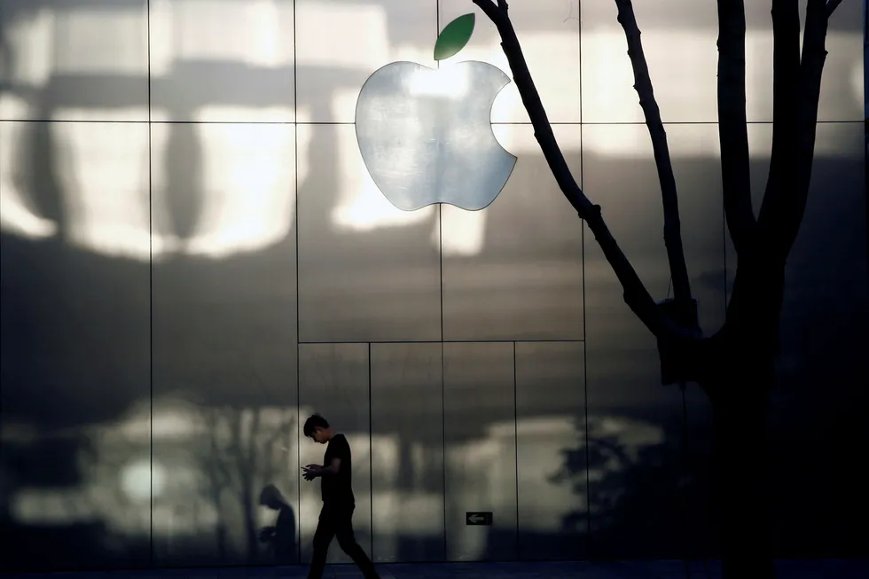 En mann går forbi en Apple-butikk i Beijing, Kina. Foto: REUTERS/Thomas Peter/File Photo