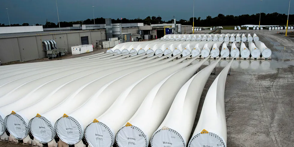 A worker walks along finished blades awaiting transport at the Siemens wind turbine blade plant in Fort Madison, Iowa. Photograph: Timothy Fadek / Bloomberg News