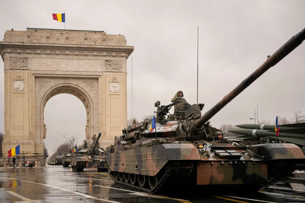 Advance: A military parade passes through the Arch de Triomphe in Bucharest, Romania, during national day celebrations