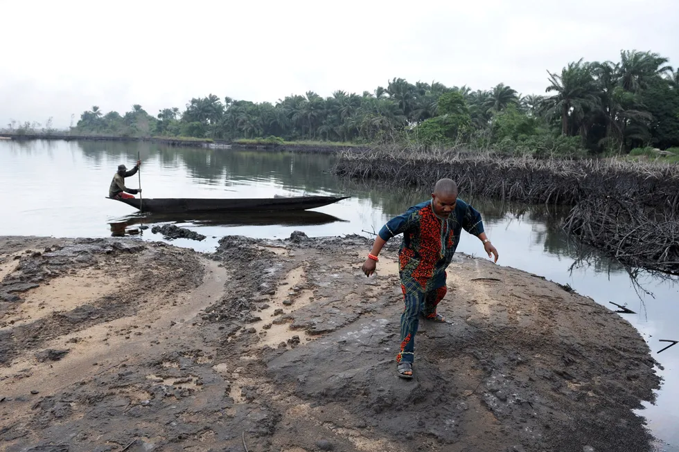 Difficult future: a man walks on spilled crude in the Niger Delta swamps near Bodo in Ogoniland, an area where the Shell Petroleum Development Company joint venture operates oil and gas acreage