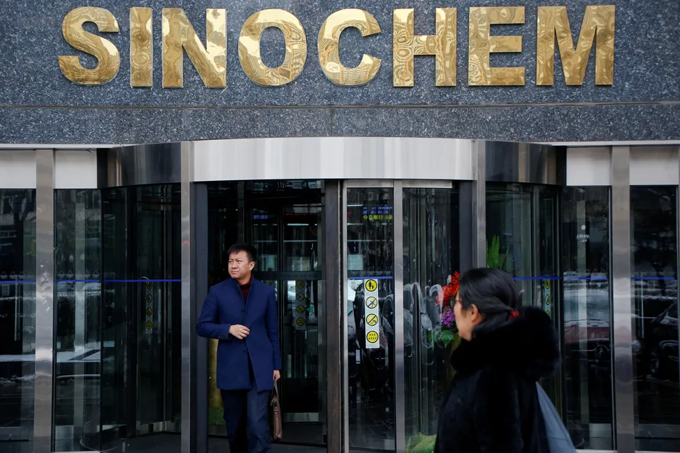 Merger go-ahead: China endorses merger between Sinochem and ChemChina. Here, a man walks out of a Sinochem office building in Beijing in 2017
