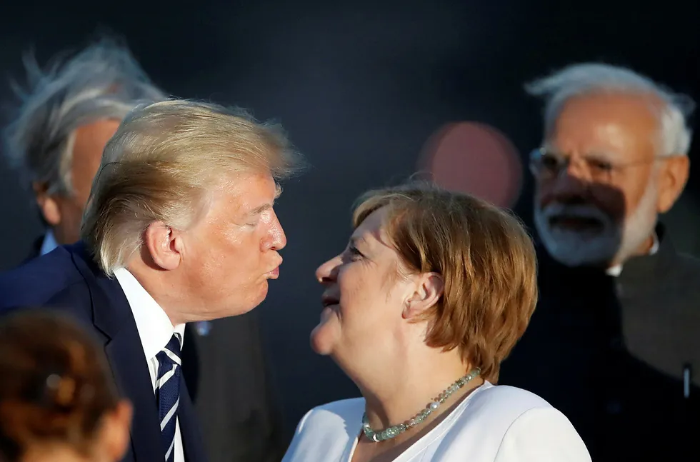 President Donald Trump og Tysklands statsminister Angela Merkel møttes under G7-ledernes fotoseanse søndag. Mandag skal de diskutere Iran og andre spørsmål på tomannshånd.