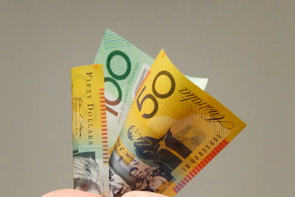 Hand it over: a man holds Australian banknotes.