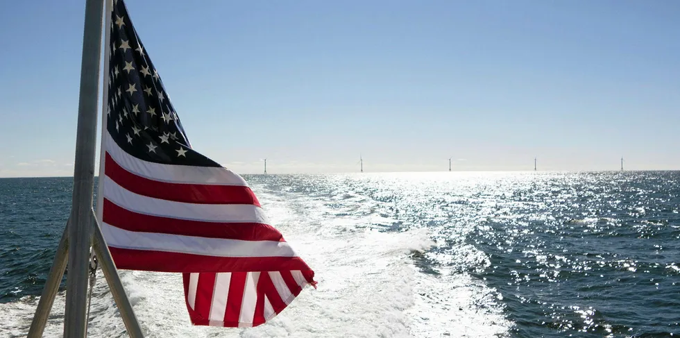 A US flag flies in front of the completed Block Island wind farm, off Rhode Island