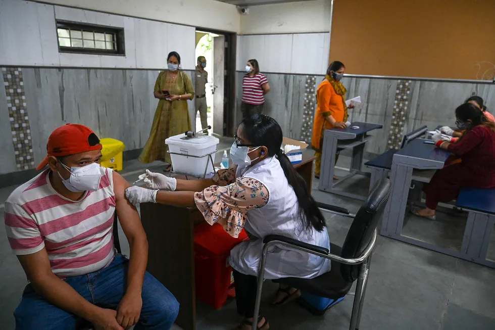 Covid crisis: a health worker inoculates a man with a dose of the Covishield Covid-19 coronavirus vaccine at a vaccination centre in New Delhi