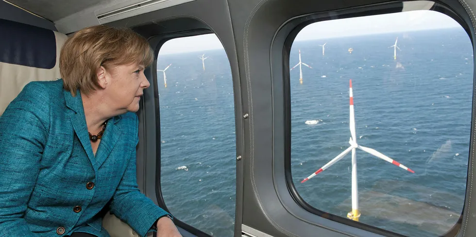 German leader Angela Merkel flies over a wind farm.
