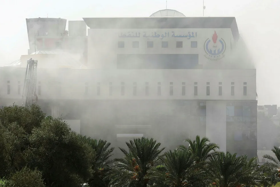 Smoke rises form the headquarters of Libyan state oil firm National Oil Corporation (NOC) after three masked persons attacked it in Tripoli, Libya September 10, 2018
