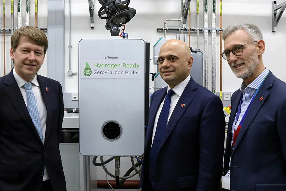 Former UK chancellor Sajid Javid (centre) is shown a "hydrogen-ready" boiler produced by manufacturer Worcester Bosch