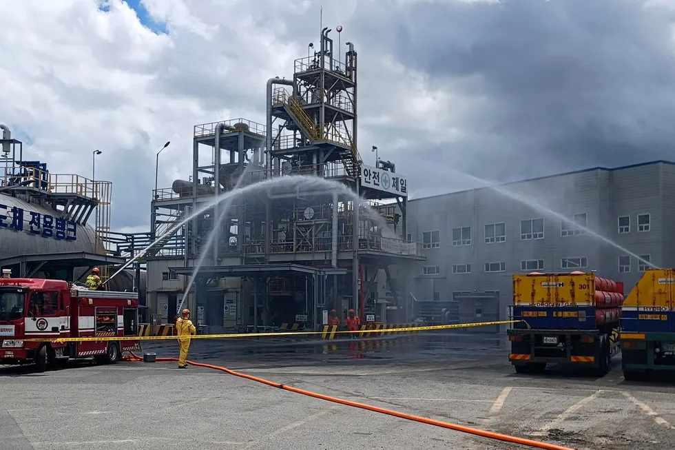 Firefighters dousing the affected part of the plant with water.