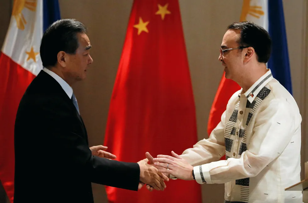 Actions: China's Foreign Minister Wang Yi meets the Philippines' Foreign Affairs Secretary Alan Peter Cayetano in Manila