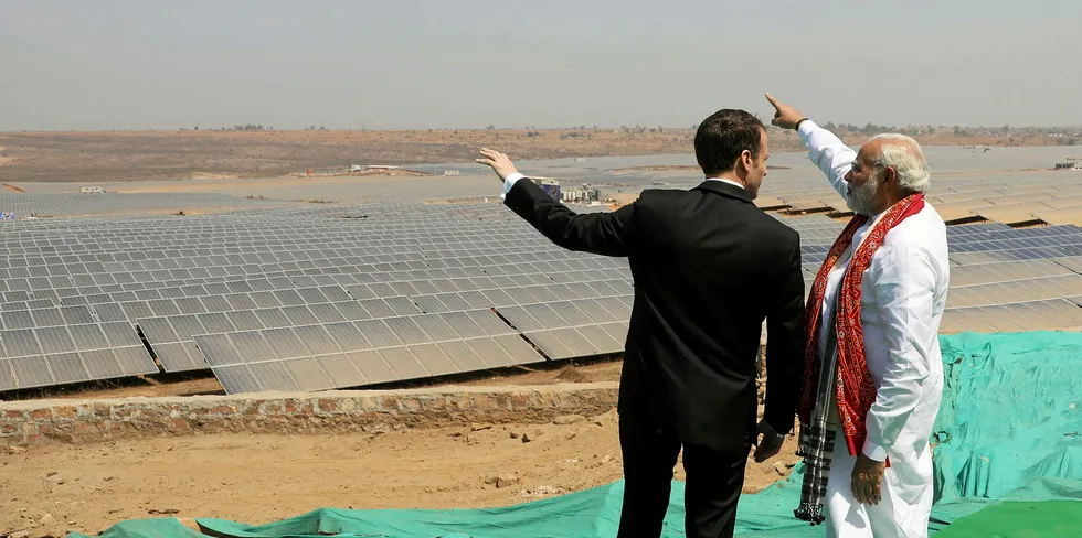 Indian Prime Minister Narendra Modi (R) and French President Emmanuel Macron stand together during the inauguration of a solar power plant in Mirzapur in Uttar Pradesh state.