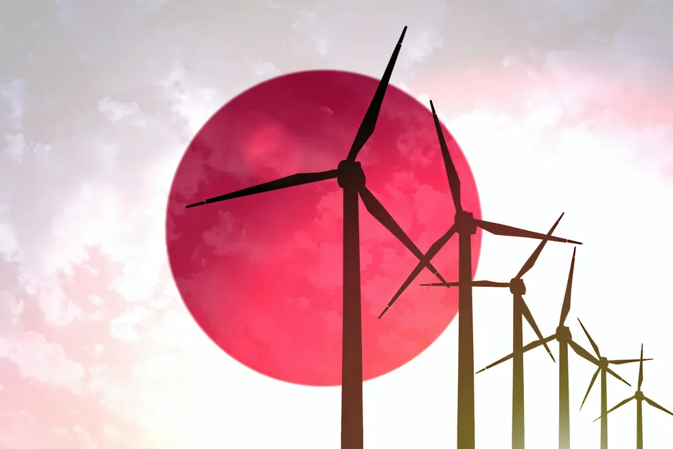 Renewables ambitions: wind turbines on the background of the Japanese flag