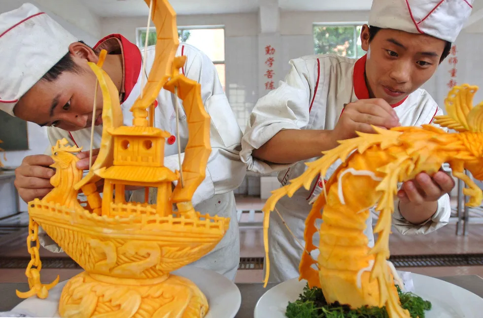 Showing their skills: students carve pumpkins at a training school for chefs in Hefei, China