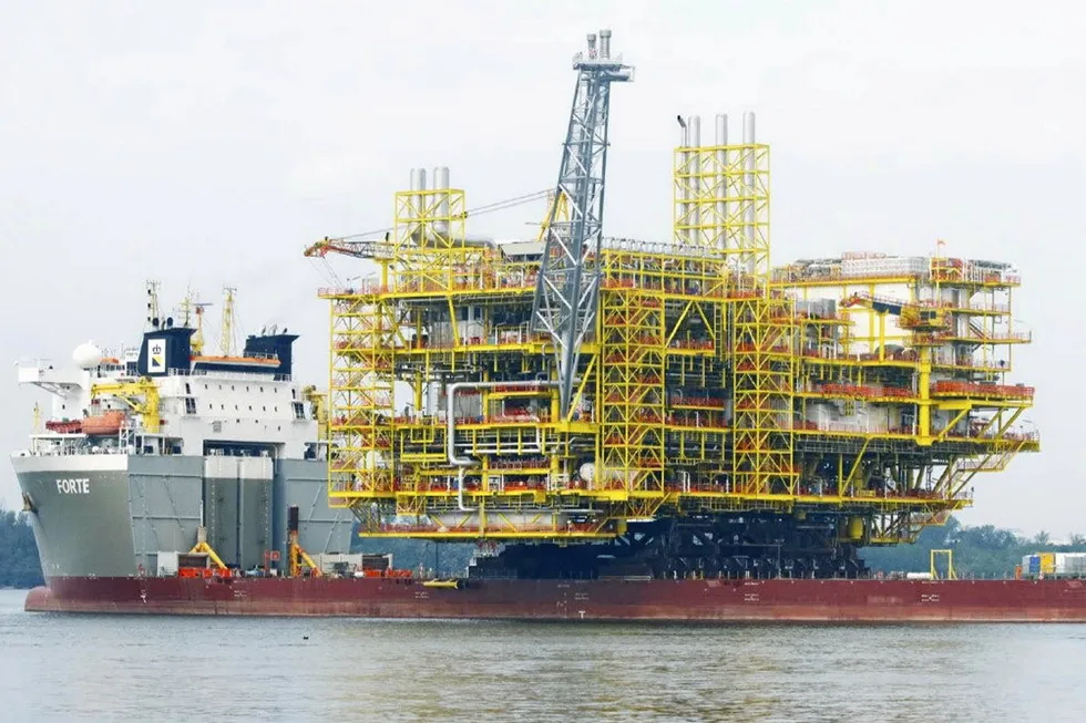 En route: the topsides of the Bokor central processing platform sails away from MMHE's yard