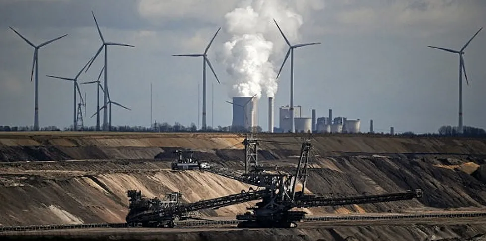 Wind turbines are seen behind RWE's Neurath open-cast mining and the coal-fired power station in Garzweiler, Germany, earlier this year