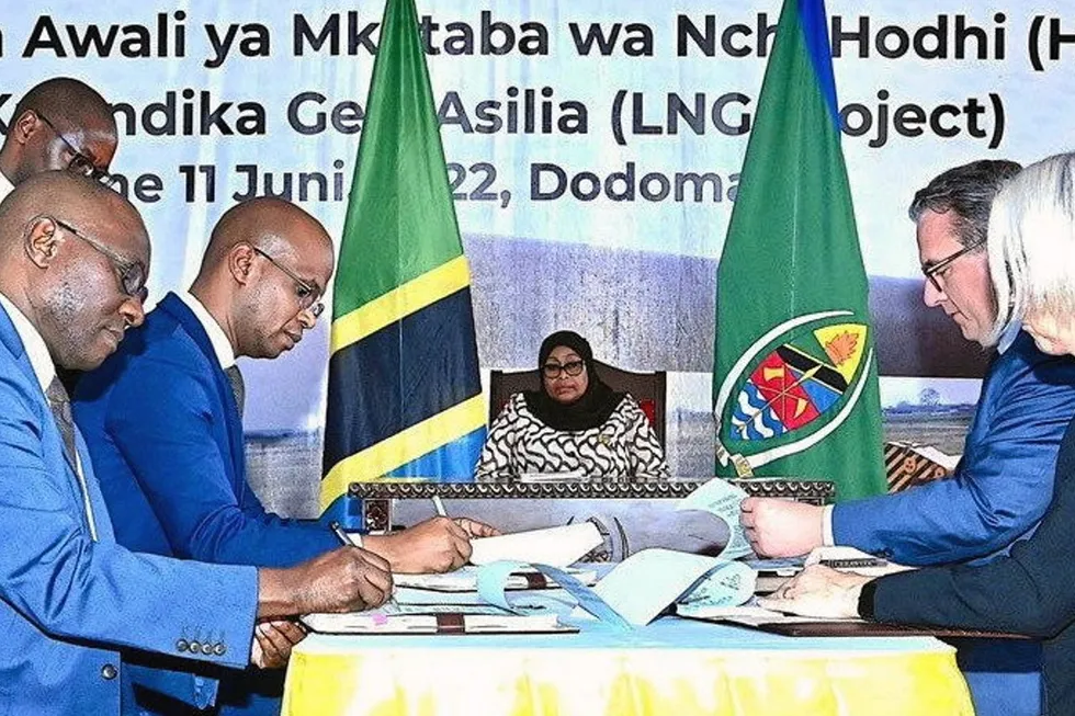 Progress: Overseen by Tanzania's President Samia Hassan (centre), Tanzanian government officials (left) and executives from Shell and Equinor (right) sign a framework deal covering the Tanzania LNG scheme.