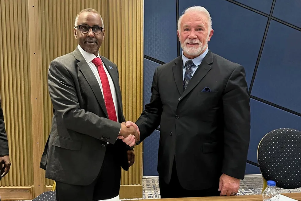 Abdirizak Omar Mohamed, Somalia's Minister of Petroleum & Mineral Resources (left) shakes hands with Liberty Petroleum chief executive Lane Franks after signing a groundbreaking upstream exploration deal.