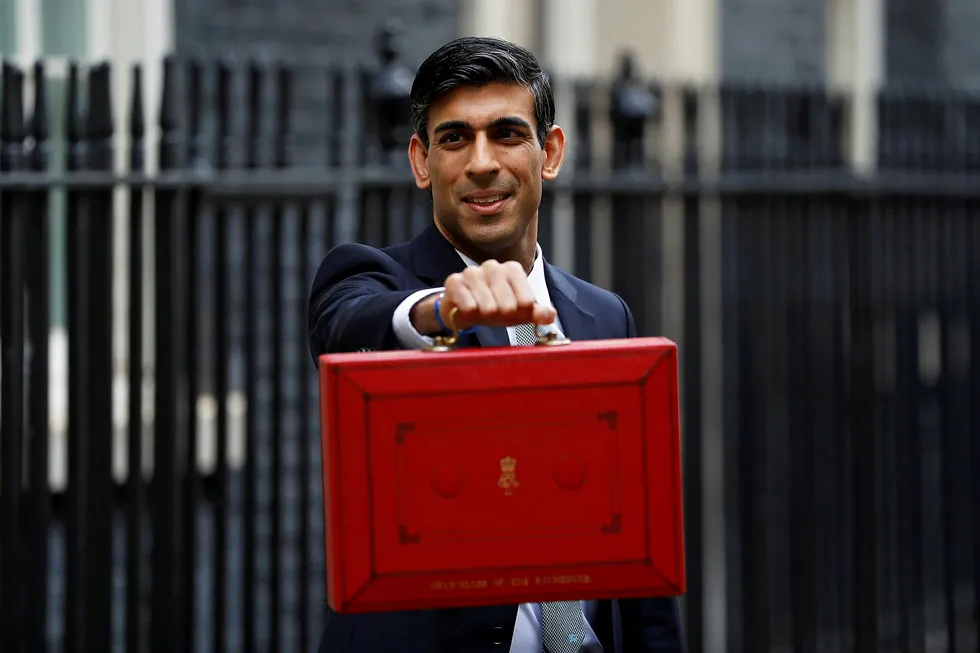 UK Chancellor of the Exchequer Rishi Sunak poses with the red budget box outside his office in Downing Street in London earlier on Wednesday