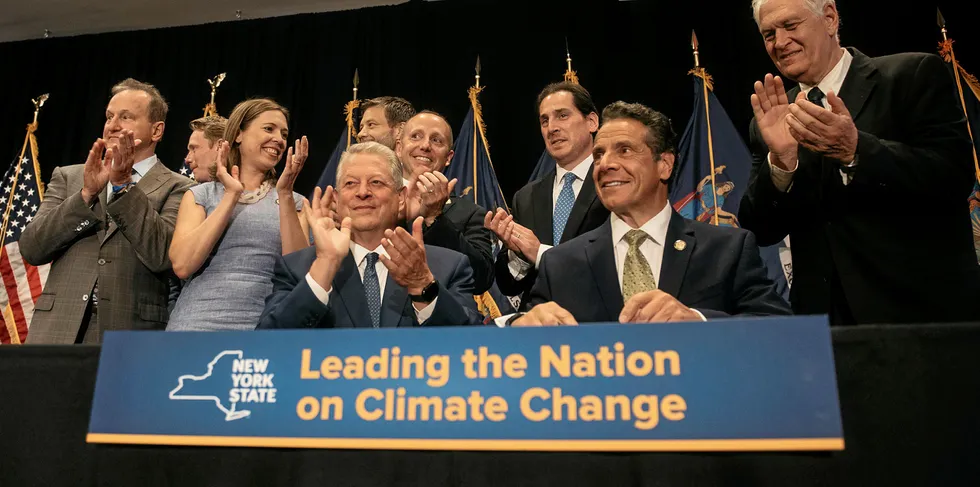 Former Vice President Al Gore joins New York Governor Andrew Cuomo as he signs the Climate Leadership and Community Protection Act at Fordham Law School in the borough of Manhattan on July 18, 2019 in New York City. Framed by Governor Cuomo as a statewide Green New Deal, the act commits New York state to expand offshore wind power, 100 percent carbon-free electricity by 2040, and mandates that 40 percent of the state's clean energy spending go towards disadvantaged communities.