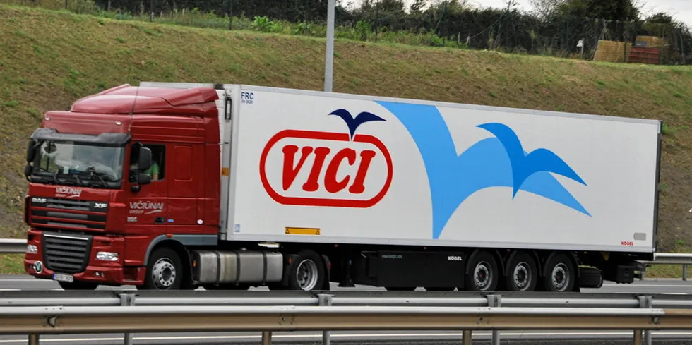 A truck branded with Viciunai Group's 'Vici' logo.