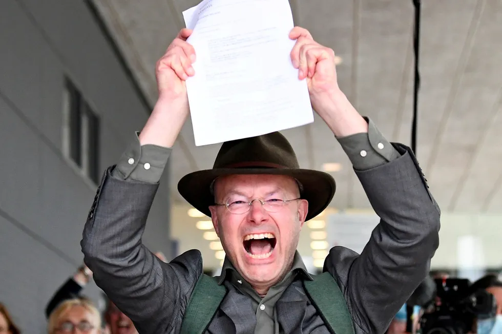 'Historic' victory: Donald Pols, director of Friends of the Earth Netherlands holds a copy of a verdict in a case brought on against Shell by environmentalist and human rights groups who demand the energy firm to cut its reliance on fossil fuels