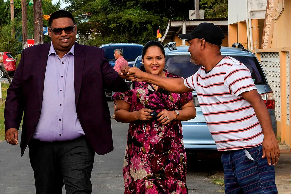Victory: Guyana's presidential candidate for the People's Progressive Party, Irfaan Ali, greets a supporter after voting in elections on 2 March 2020. His victory was confirmed five months later
