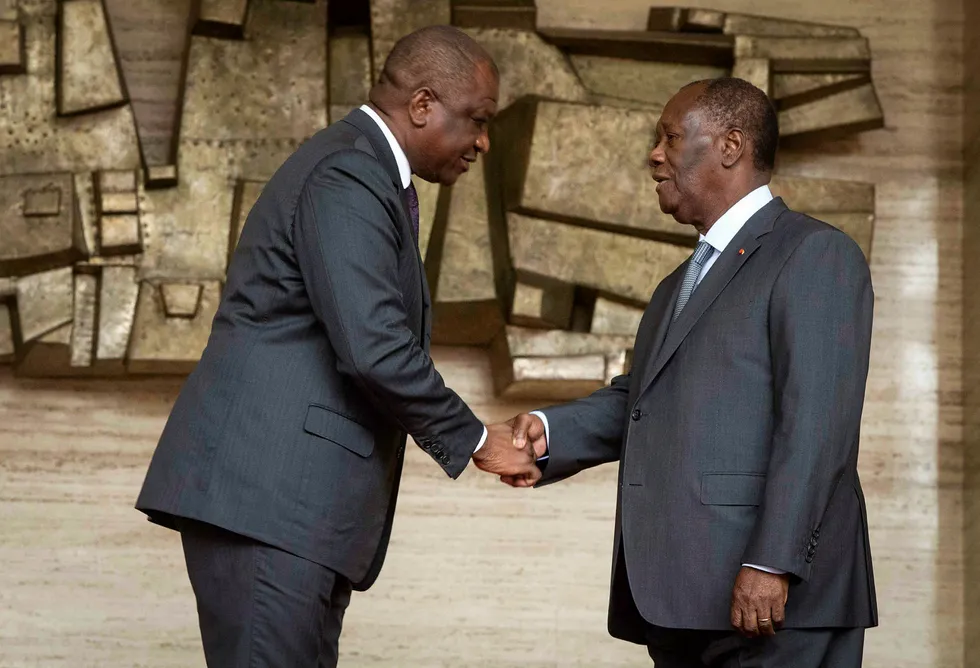 Change at top: newly appointed Ivorian Prime Minister Hamed Bakayoko (left) shaking hands with Ivorian President Alassane Ouattara