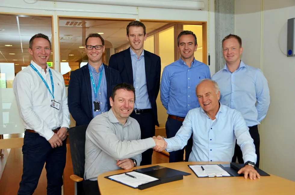 It's a deal: Transocean technical sourcing director Scott McKaig (front, left) and MHWirth chief executive Finn Amund Nordby (front, right) after signing the $100 million maintenace deal in Kristiansand, Norway
